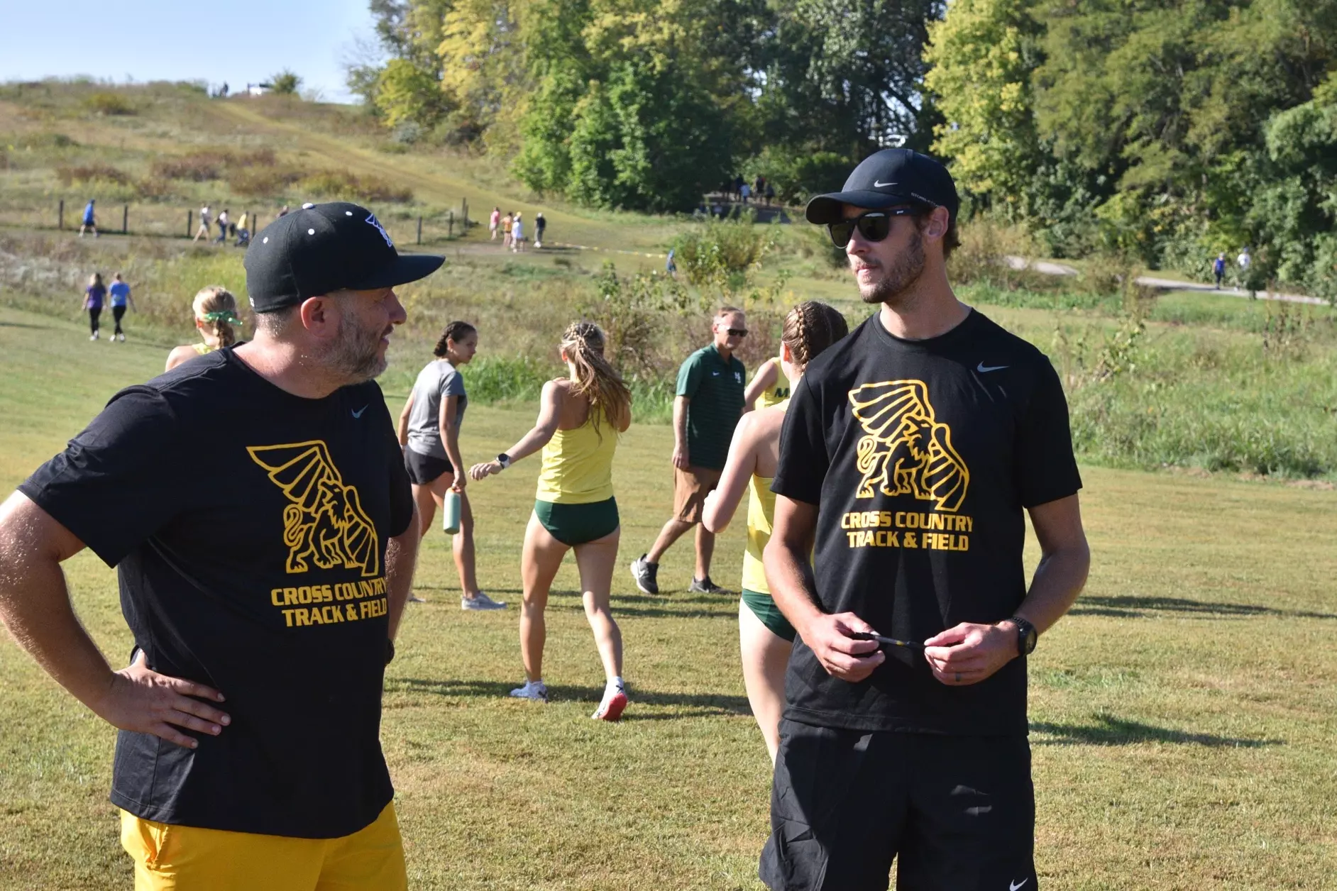 Cody Ingold (left) talks with assistant coach Sean Gosewich (right) during the 2024 Griffon Invite/ Photo courtesy of MoWest Athletics