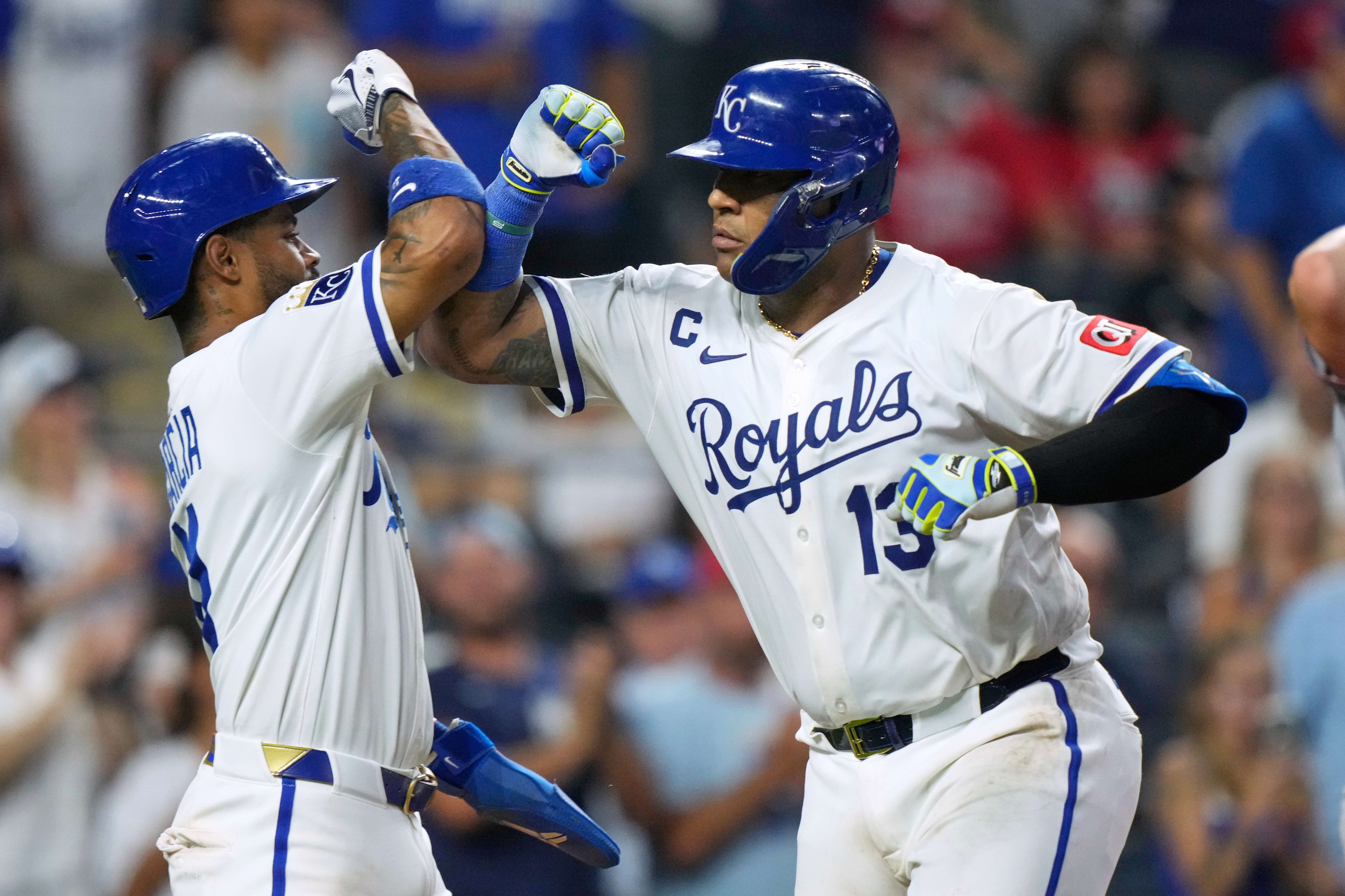 Kansas City Royals' Salvador Perez (13) celebrates with Maikel Garcia after hitting a two-run home run during the sixth inning of a baseball game against the Washington Nationals, Monday, Aug. 11, 2025, in Kansas City, Mo. (AP Photo/Charlie Riedel)
