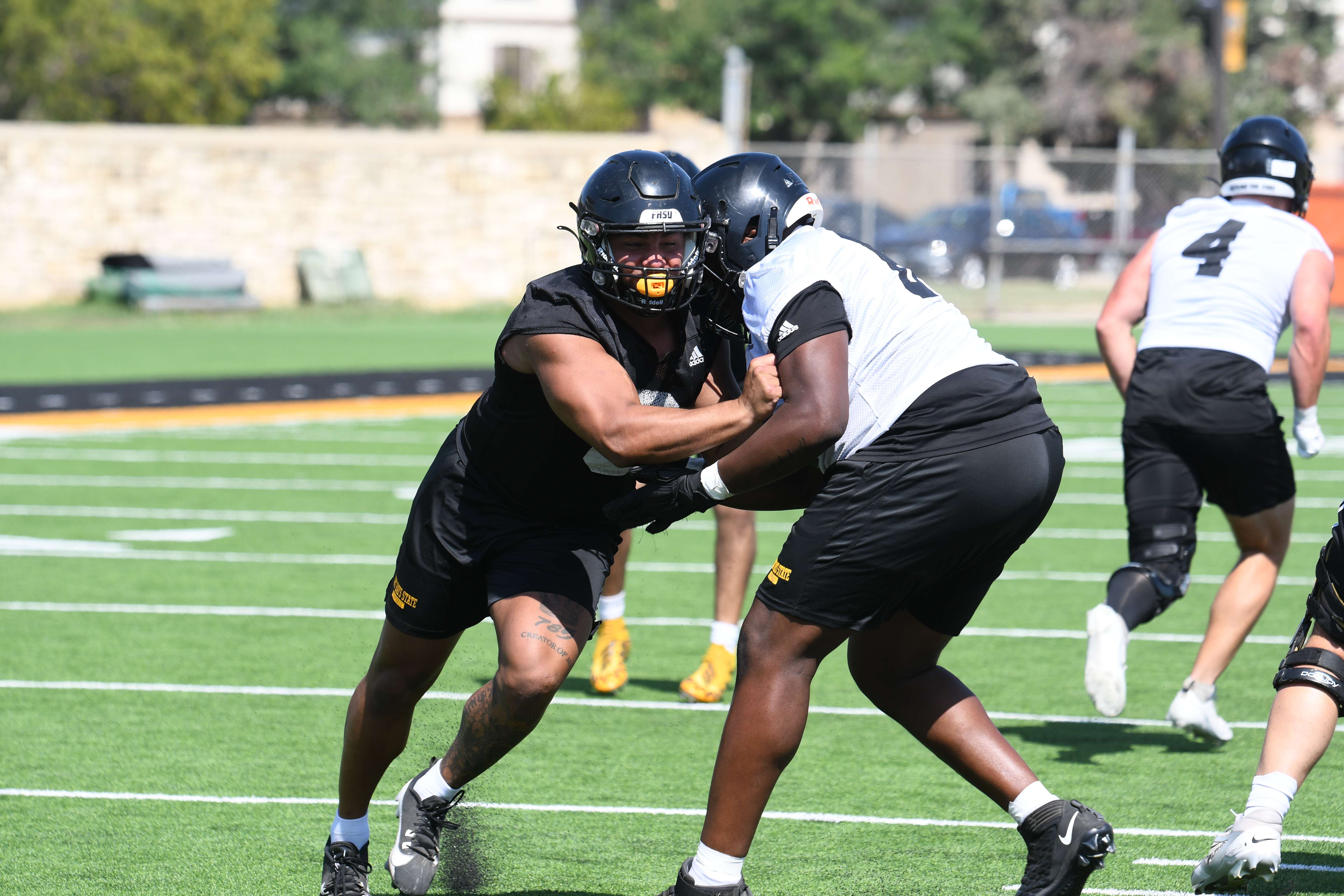 Fort Hays State defensive end Gaven Haselhorst (8) takes on a blocker during FHSU preseason camp. (FHSU Athletics photo/Ryan Prickett)