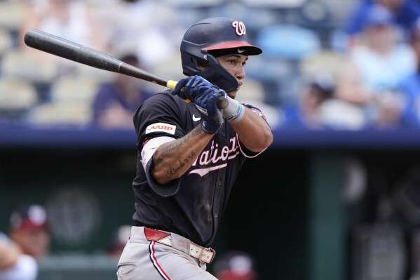 Washington Nationals' Daylen Lile watches his RBI single during the ninth inning of a baseball game against the Kansas City Royals, Wednesday, Aug. 13, 2025, in Kansas City, Mo. (AP Photo/Charlie Riedel)