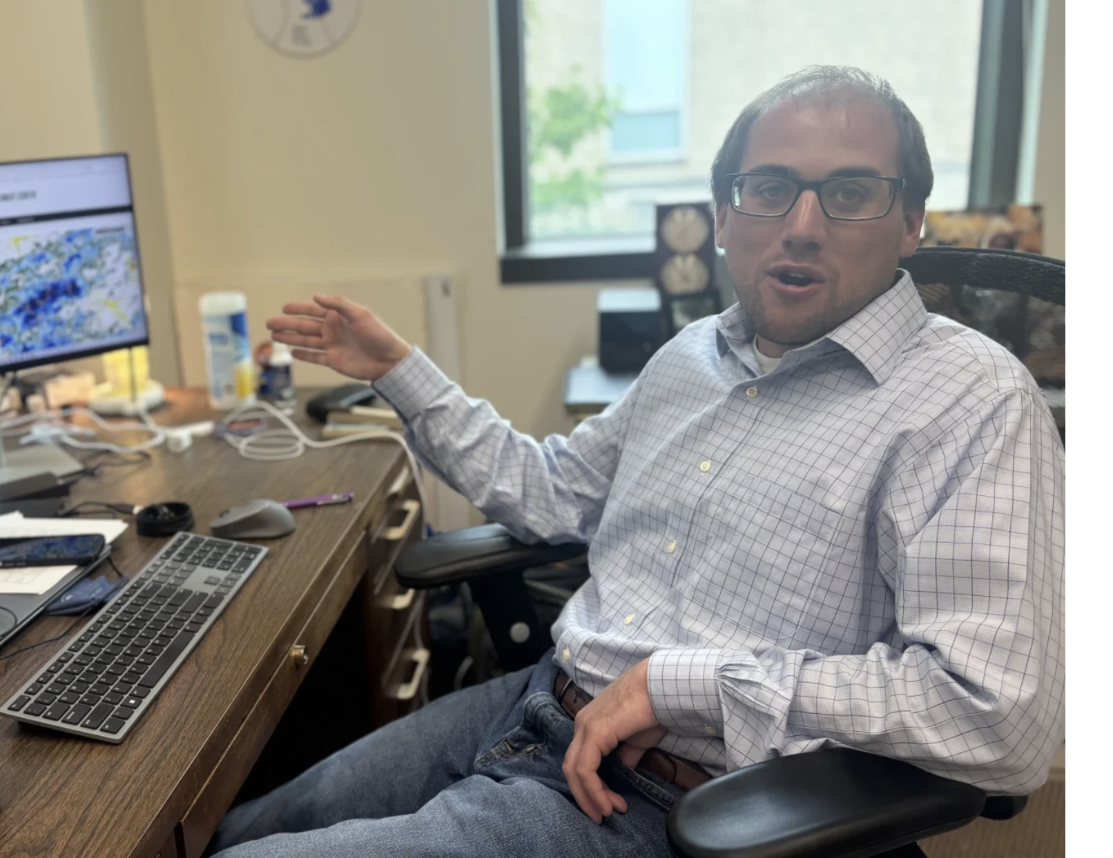 Missouri State Climatologist Zack Leasor examines weather reports to assess drought from his office in Columbia on May 29 (Harshawn Ratanpal/KBIA).