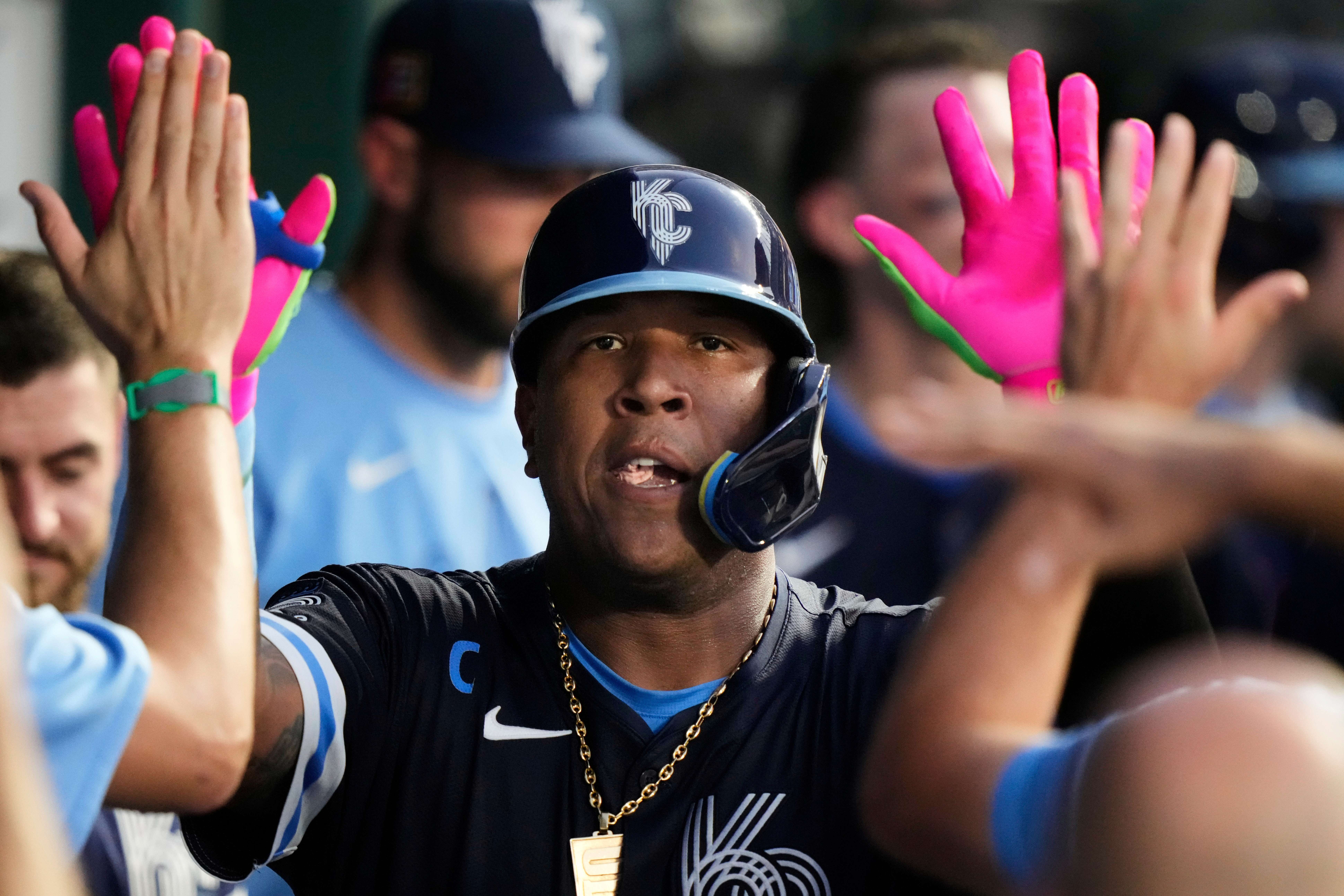 Kansas City Royals' Salvador Perez celebrates in the dugout after hitting a solo home run during the fourth inning of a baseball game against the Chicago White Sox, Friday, Aug. 15, 2025, in Kansas City, Mo. (AP Photo/Charlie Riedel)
