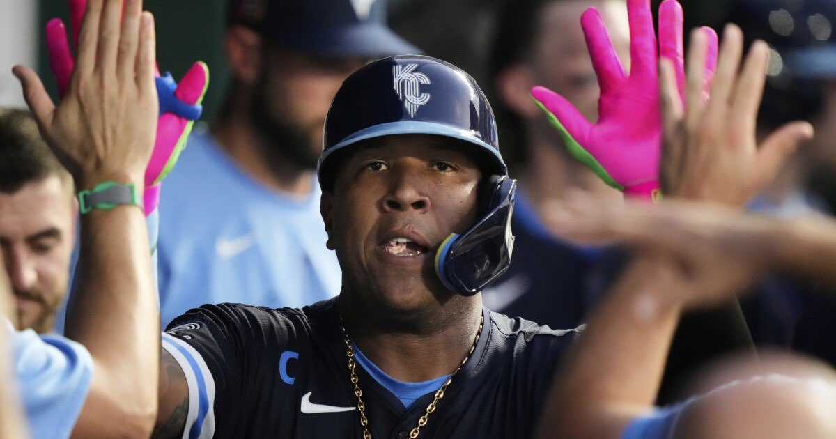 Kansas City Royals' Salvador Perez celebrates in the dugout after hitting a solo home run during the fourth inning of a baseball game against the Chicago White Sox, Friday, Aug. 15, 2025, in Kansas City, Mo. (AP Photo/Charlie Riedel)