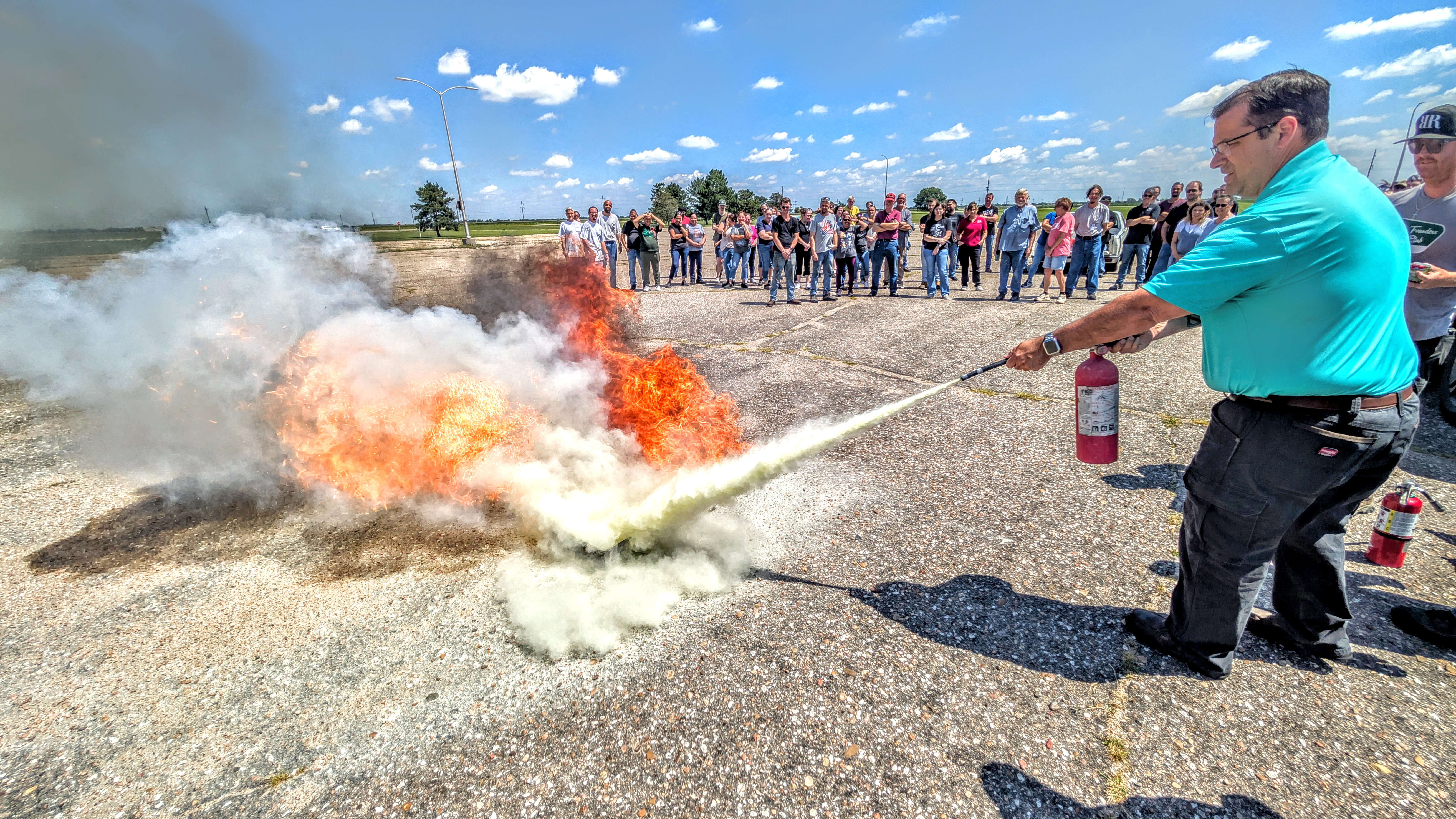 Fuller Industries Inc. Vice President of Operations Chris Cowles practices using a fire extinguisher during the annual fire extinguisher training at the Fuller facility west of Great Bend on Wednesday afternoon.