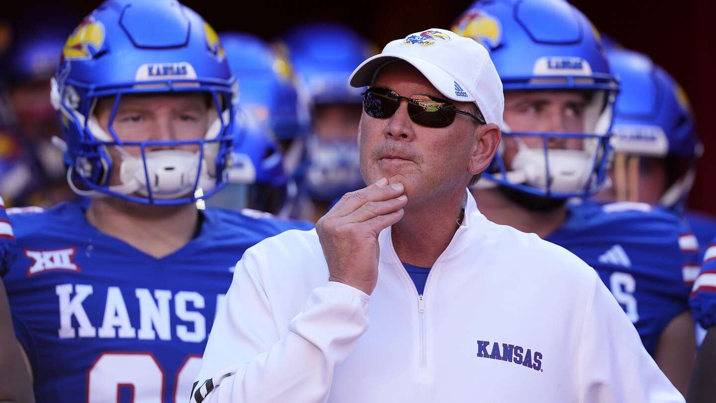 Kansas head coach Lance Leipold stands with his players before running onto the field before an NCAA college football game against Houston on Oct. 19, 2024, in Kansas City, Mo. (AP Photo/Charlie Riedel, File)