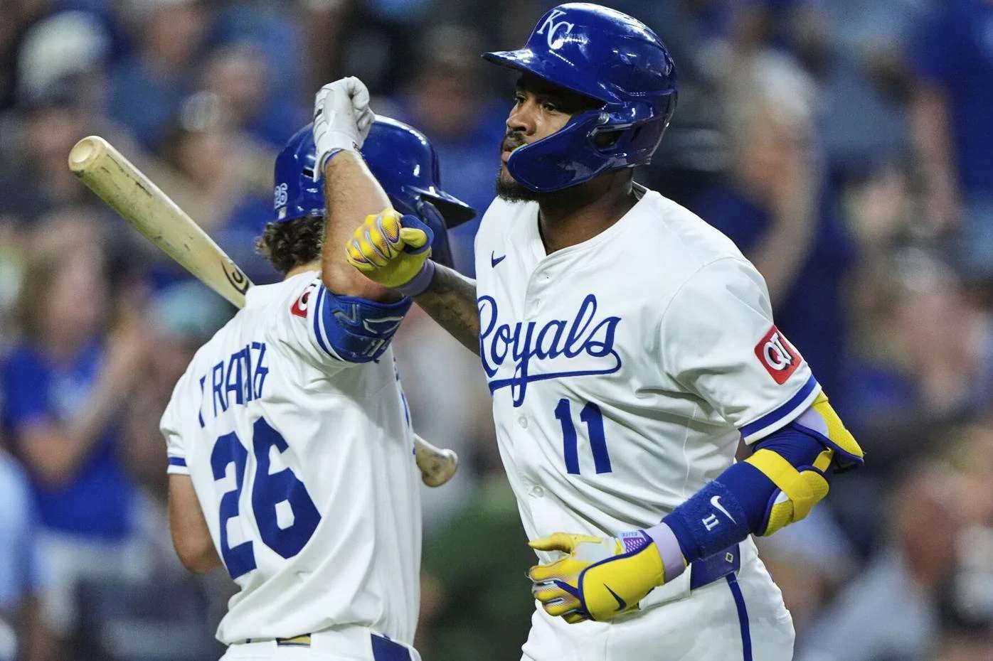 Kansas City Royals' Maikel Garcia (11) celebrates with Adam Frazier (26) after hitting a solo home run during the fifth inning of a baseball game against the Texas Rangers, Monday, Aug. 18, 2025, in Kansas City, Mo. (AP Photo/Charlie Riedel)