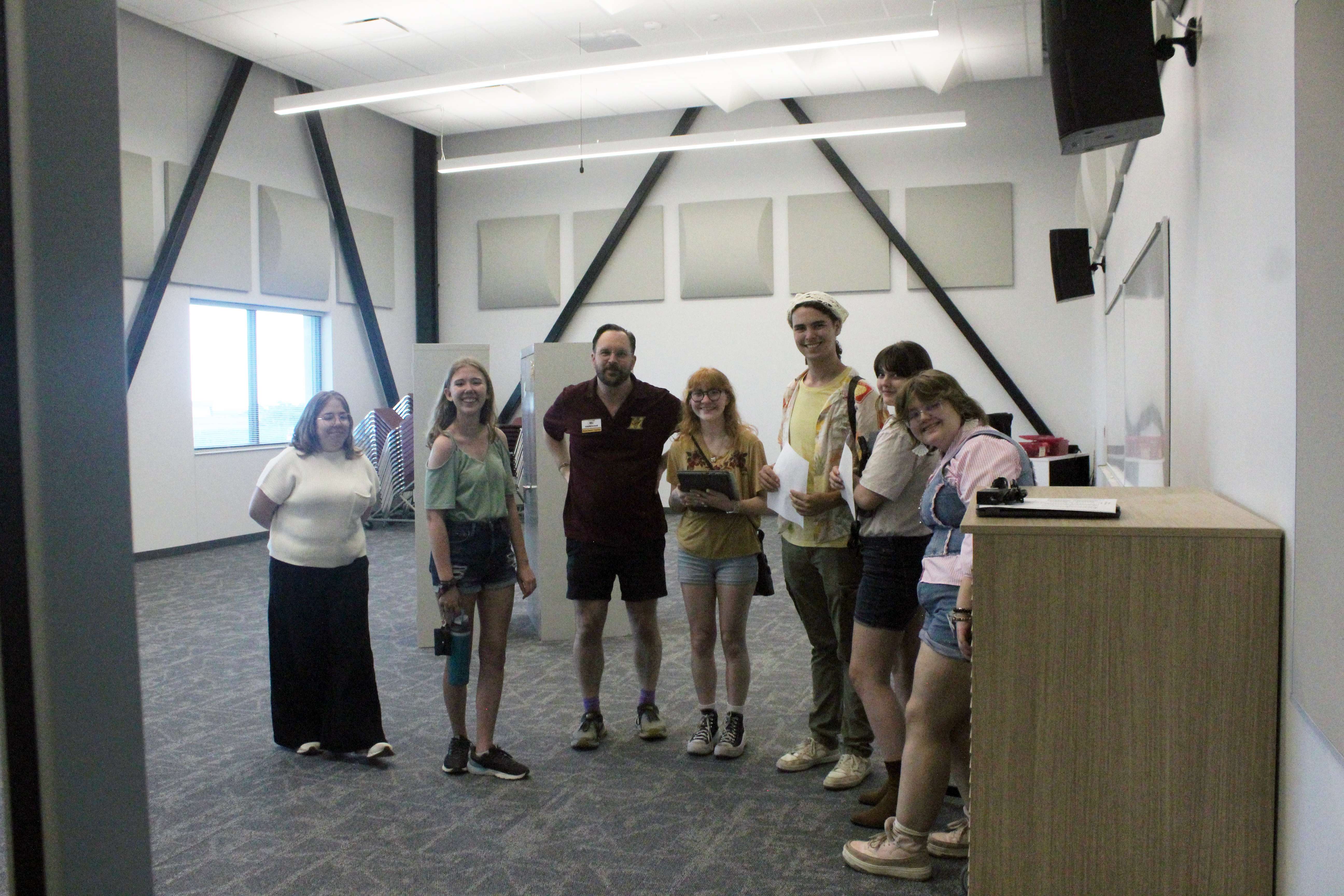 Choir director Alex Underwood with students in the new chorus room. The new band and chorus rooms are adjacent to practice rooms. A private donor has given music stands, keyboards and audio equipment to outfit those rooms. Photo by Cristina Janney/Hays Post