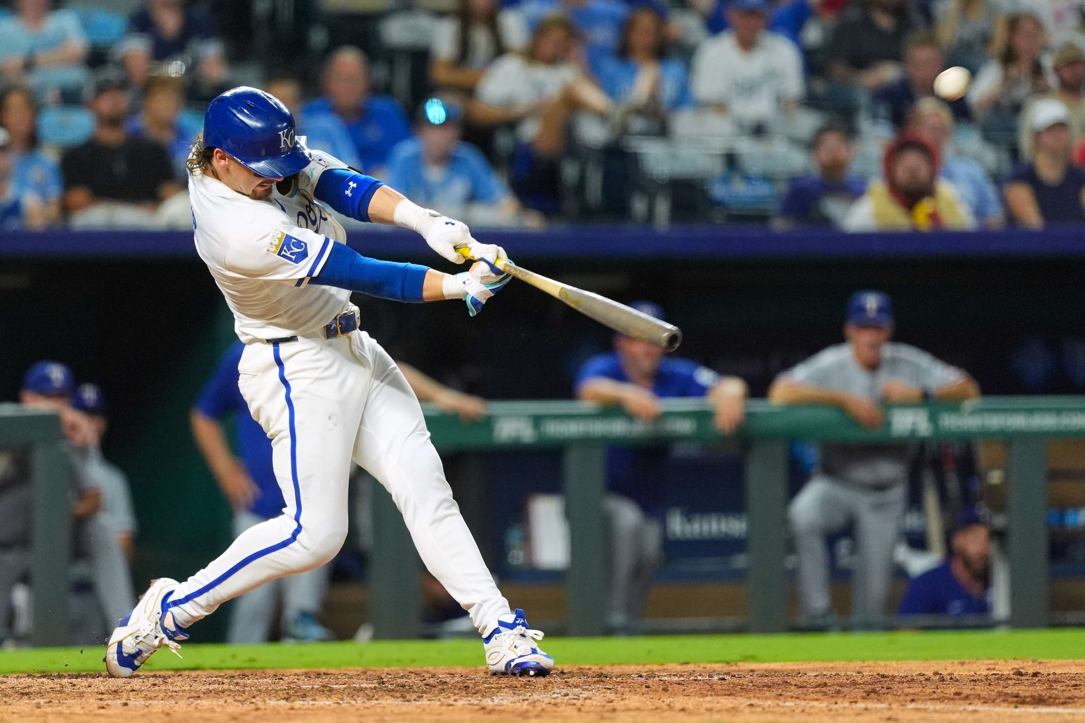 Kansas City Royals' Bobby Witt Jr. hits a two-run home run for his 100th career home run during the eighth inning of a baseball game against the Texas Rangers, Tuesday, Aug. 19, 2025, in Kansas City, Mo. (AP Photo/Charlie Riedel)