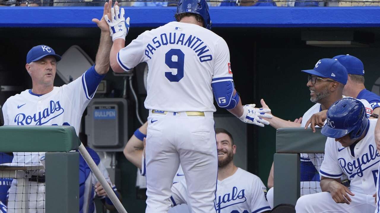 Kansas City Royals' Vinnie Pasquantino celebrates with teammates after hitting a solo home run during the first inning of a baseball game against the Texas Rangers, Tuesday, Aug. 19, 2025, in Kansas City, Mo. (AP Photo/Charlie Riedel)