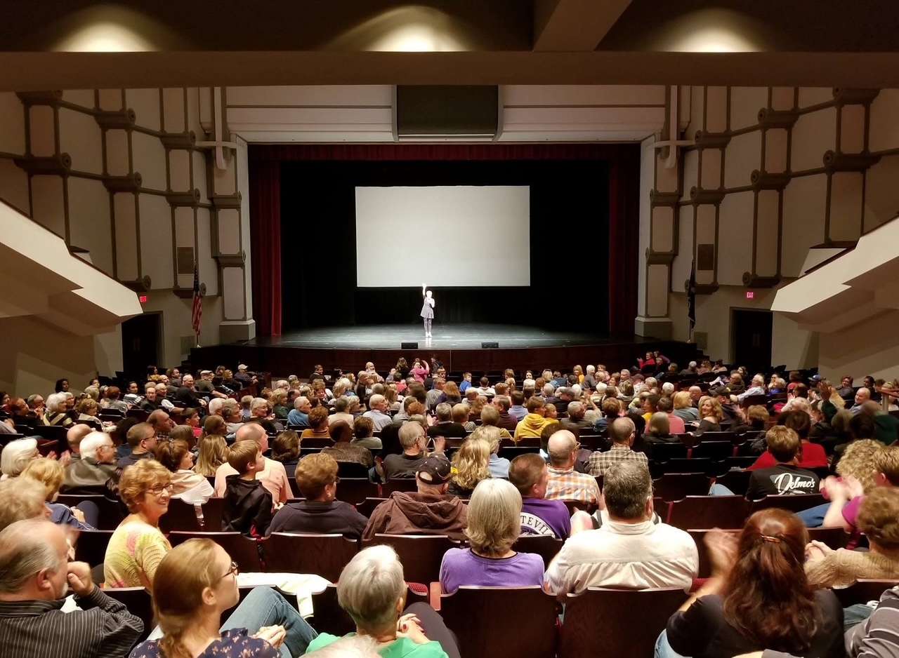 A crowd at the showing of the Swiss documentary on Hays —"Quiet America" in 2017. Brenda Meder is on stage, welcoming guests and providing background information on the project, which was filmed in Hays in 1976. The Hays Arts Council secured the rights from the Swiss film company for this first-ever showing in Hays.