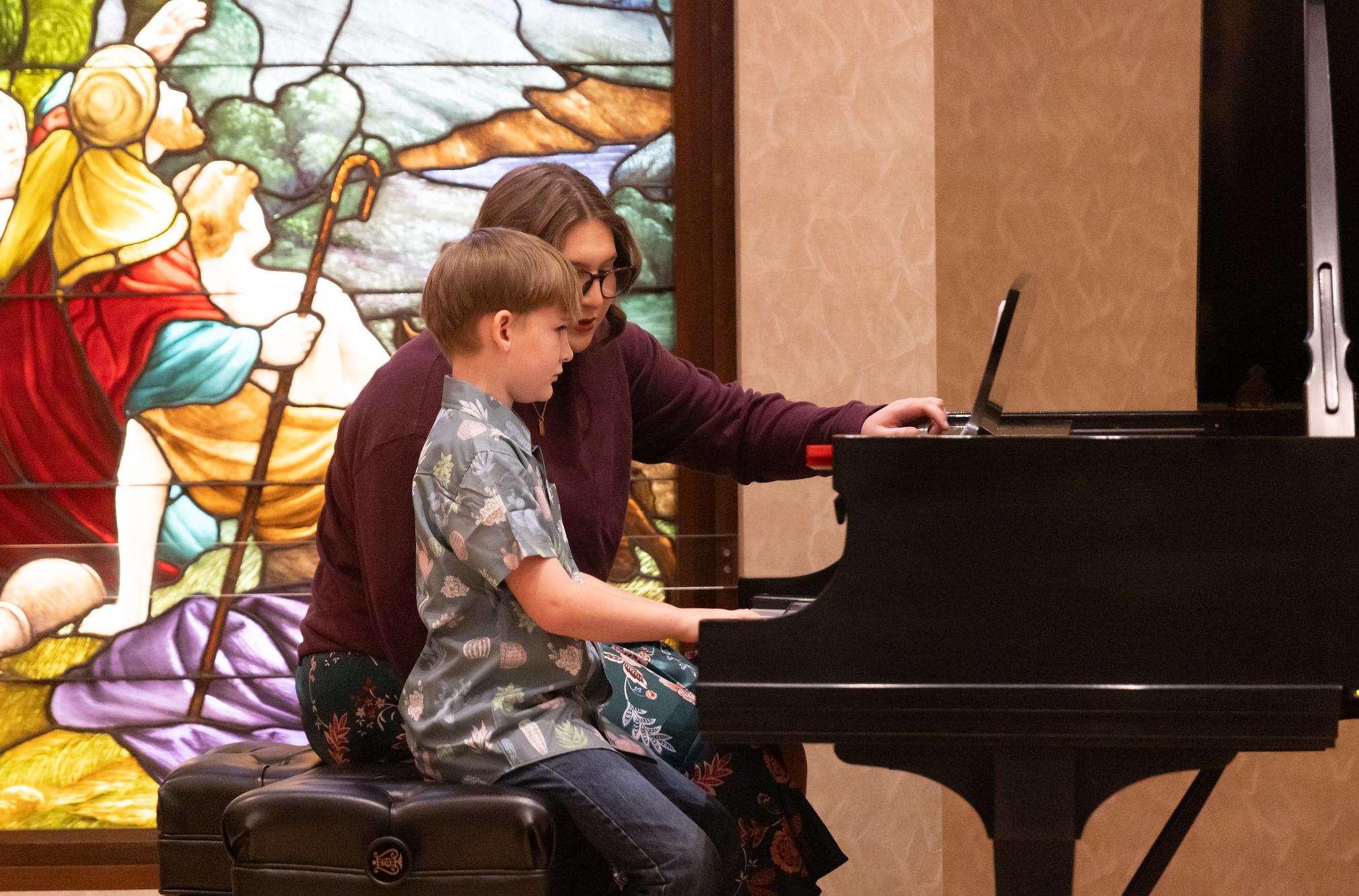 A Barton student receives instruction on the piano from Barton music major Ella McNett last year as a part of the Community Music School, which has added several instruments that are available for lessons this year.