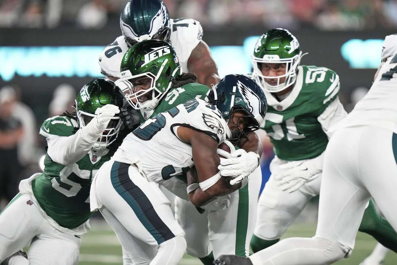 Philadelphia Eagles running back Keilan Robinson (35) carries against New York Jets defensive end Kingsley Jonathan (57) and defensive tackle Derrick Nnadi (91) in the first half of a preseason NFL football game in East Rutherford, N.J., Friday, Aug. 22, 2025. (AP Photo/Frank Franklin)