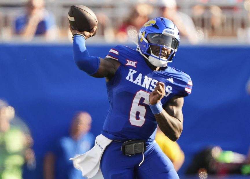 Kansas quarterback Jalon Daniels passes during the first half of an NCAA college football game against Fresno State, Saturday, Aug. 23, 2025 in Lawrence, Kan. (AP Photo/Charlie Riedel)