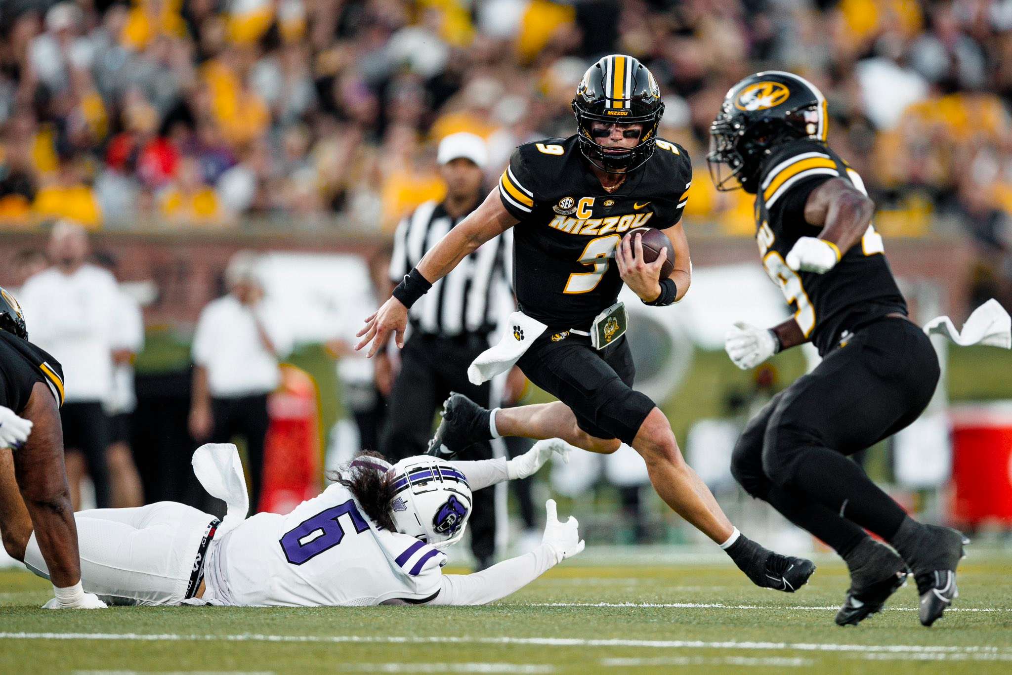 Beau Pribula scrambles in the first half past Bears defender Duncan Parham (6)/ Photo courtesy of Mizzou Football on X