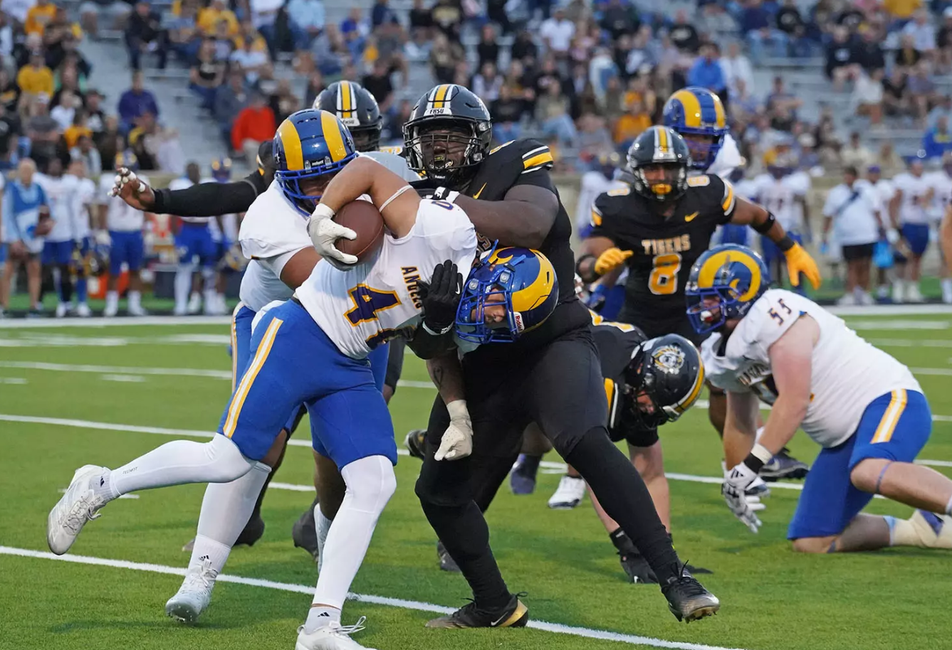 Fort Hays State's defensive lineman Jakolbe Wilson (91) makes a tackle on Angelo State running back Cameron Dischler (40) in the first half of an NCAA college football game on Thursday, August 28, 2025 in Hays, Kan. (FHSU Athletics photo/Gillian Lynch)