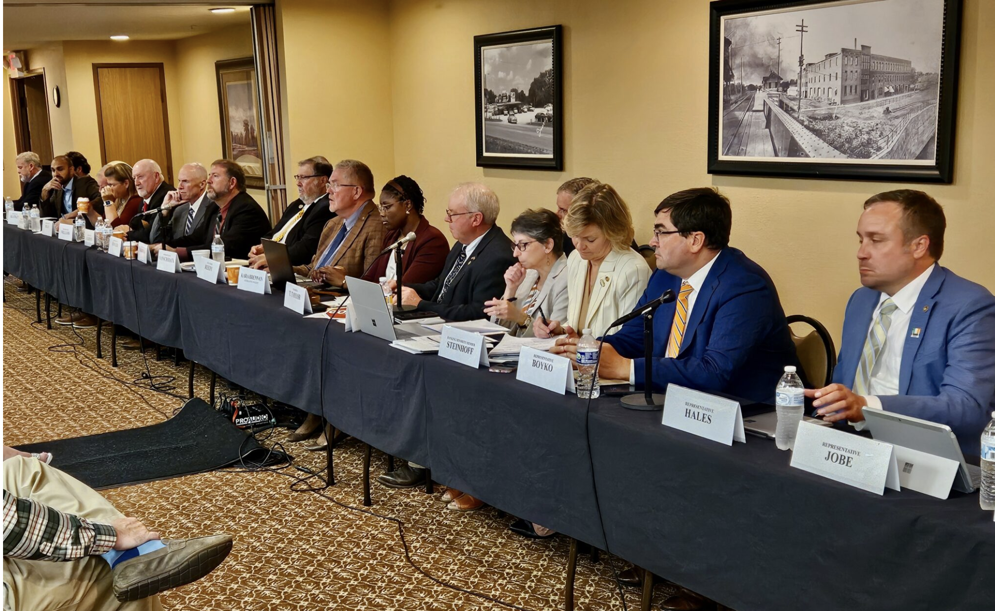 Members of the House Special Interim Committee on Property Tax Reform, chaired by state Rep. Tim Taylor, fifth from right, listen to testimony at a hearing Wednesday in Macon. (Rudi Keller/Missouri Independent)