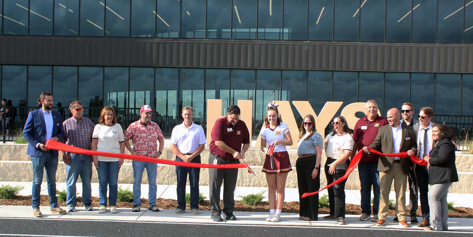 School board members, administrators and representatives of Nabholz Construction and DLR architects cut the ribbon on new Hays High on Friday night. Pictured second from left, board members Curt Vajnar, Ruth Ruder, Ken Brooks, Allen Park, Hays High Principal Shawn Henderson, Student Body Vice-President Senior XX, school board members Jayme Goetz and Meagan Zampieri-Lillpopp, Hays USD Superintendent Ron Wilson, Brett Collins, Nahbolz Construction and far right, Ishita Banerjii, DLR project manager. Photo by Cristina Janney/Hays Post