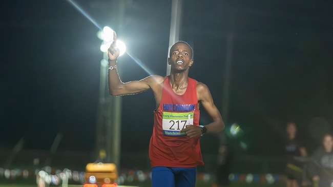 Sophomore Cornelius Kogo is the first of four-straight Blue Dragon men's runners to cross the finish line and lead the No. 4-ranked Blue Dragon men to the Terry Masterson Twilight Classic team title on Friday at Fun Valley. (Andrew Carpenter/Digital Fox Photography)