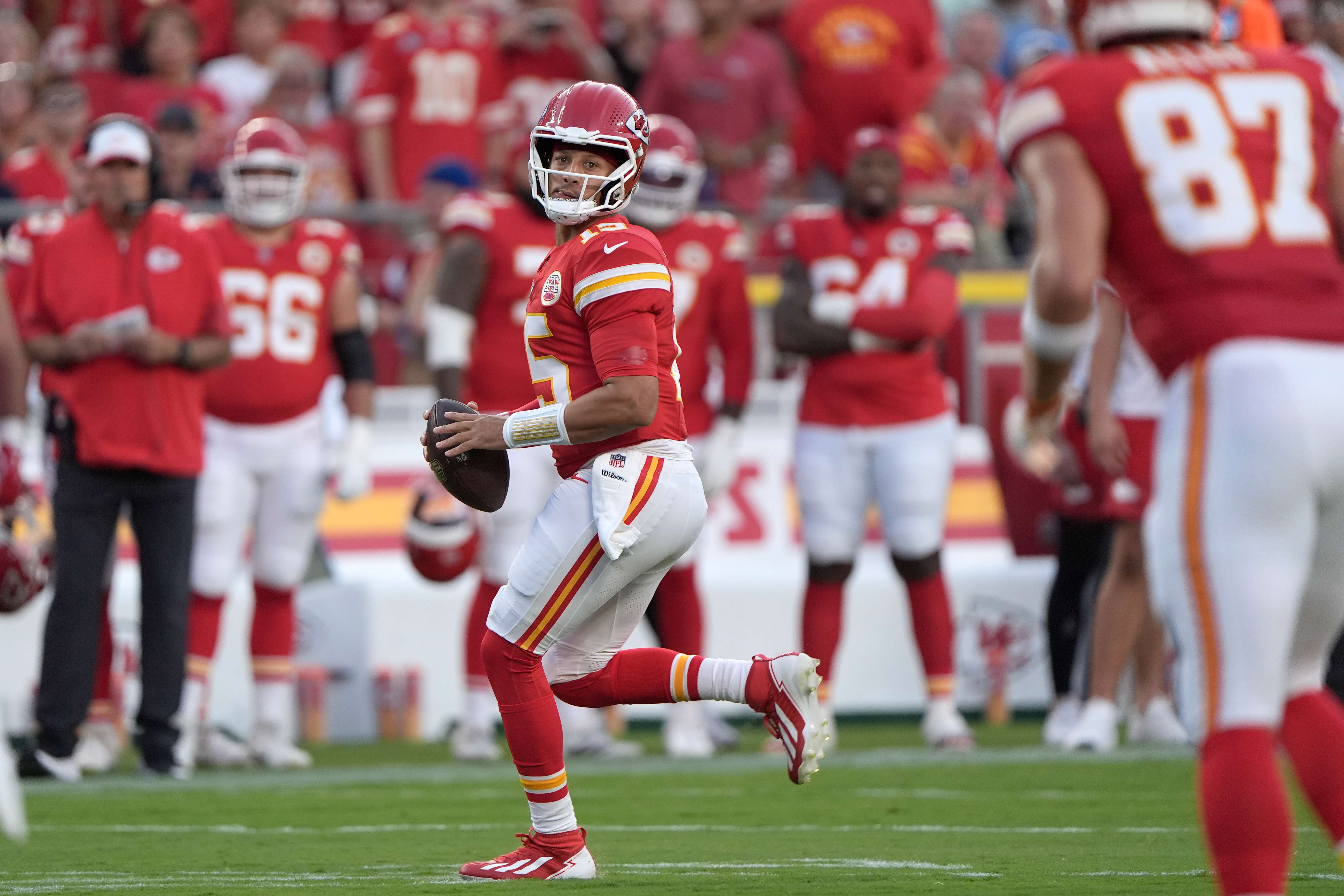 Kansas City Chiefs quarterback Patrick Mahomes scrambles during the first half of a preseason NFL football game against the Chicago Bears Friday, Aug. 22, 2025, in Kansas City, Mo. (AP Photo/Charlie Riedel)