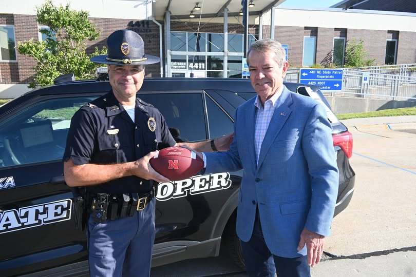 Governor Jim Pillen assists in Game Day football handoff Sept. 2, 2025.