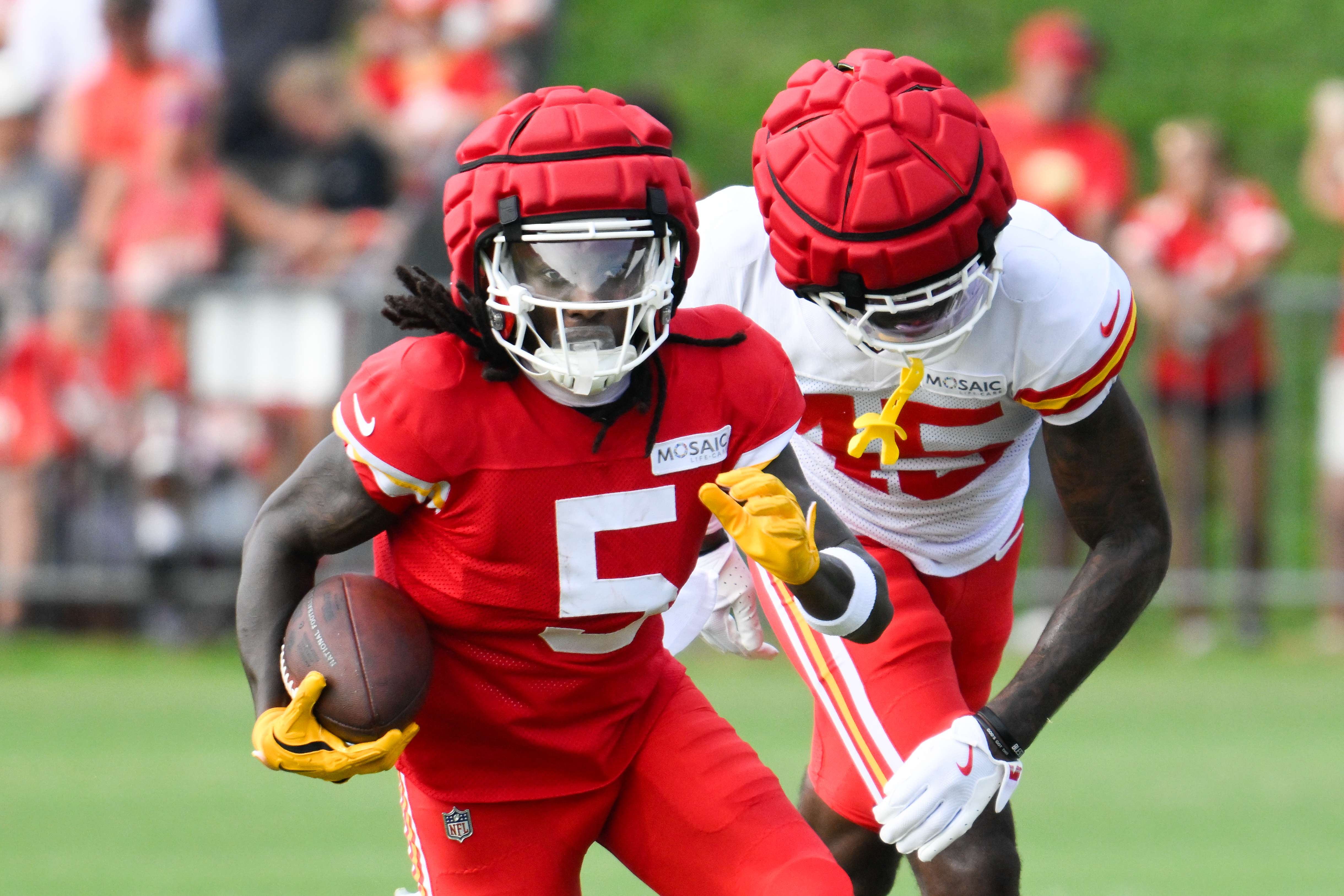 FILE - Kansas City Chiefs wide receiver Marquise "Hollywood" Brown (5) runs after a catch as cornerback Miles Battle (45) defends during NFL football training camp on July 27, 2024, in St. Joseph, Mo. (AP Photo/Reed Hoffmann)