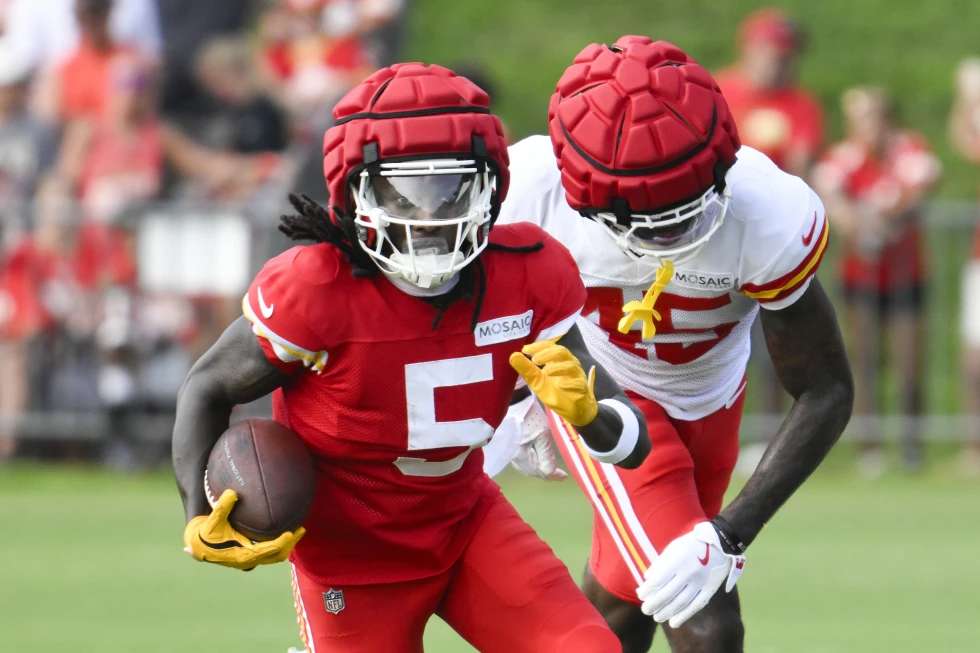 FILE - Kansas City Chiefs wide receiver Marquise "Hollywood" Brown (5) runs after a catch as cornerback Miles Battle (45) defends during NFL football training camp on July 27, 2024, in St. Joseph, Mo. (AP Photo/Reed Hoffmann)