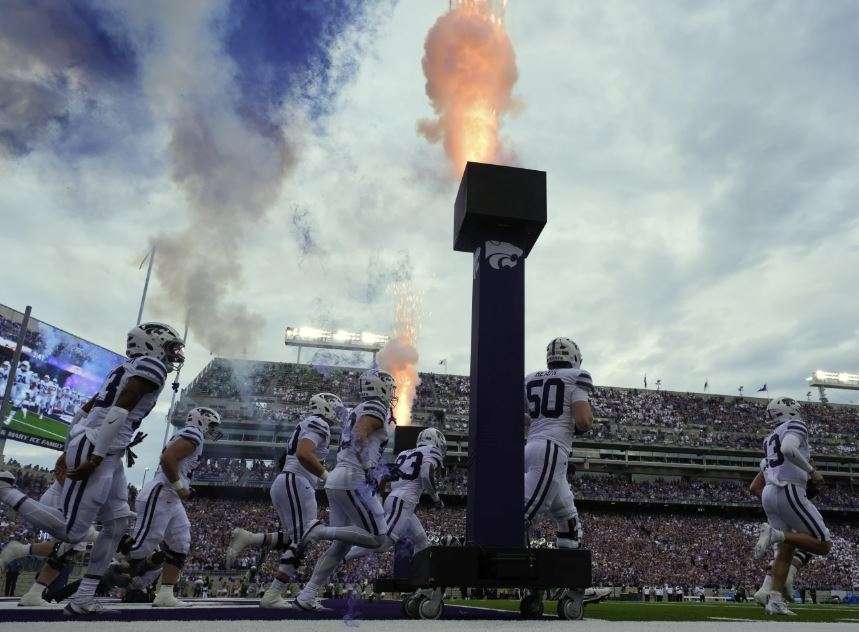 Kansas State players run onto the field before an NCAA college football game against North Dakota, Saturday, Aug. 30, 2025, in Manhattan, Kan. (AP Photo/Charlie Riedel)