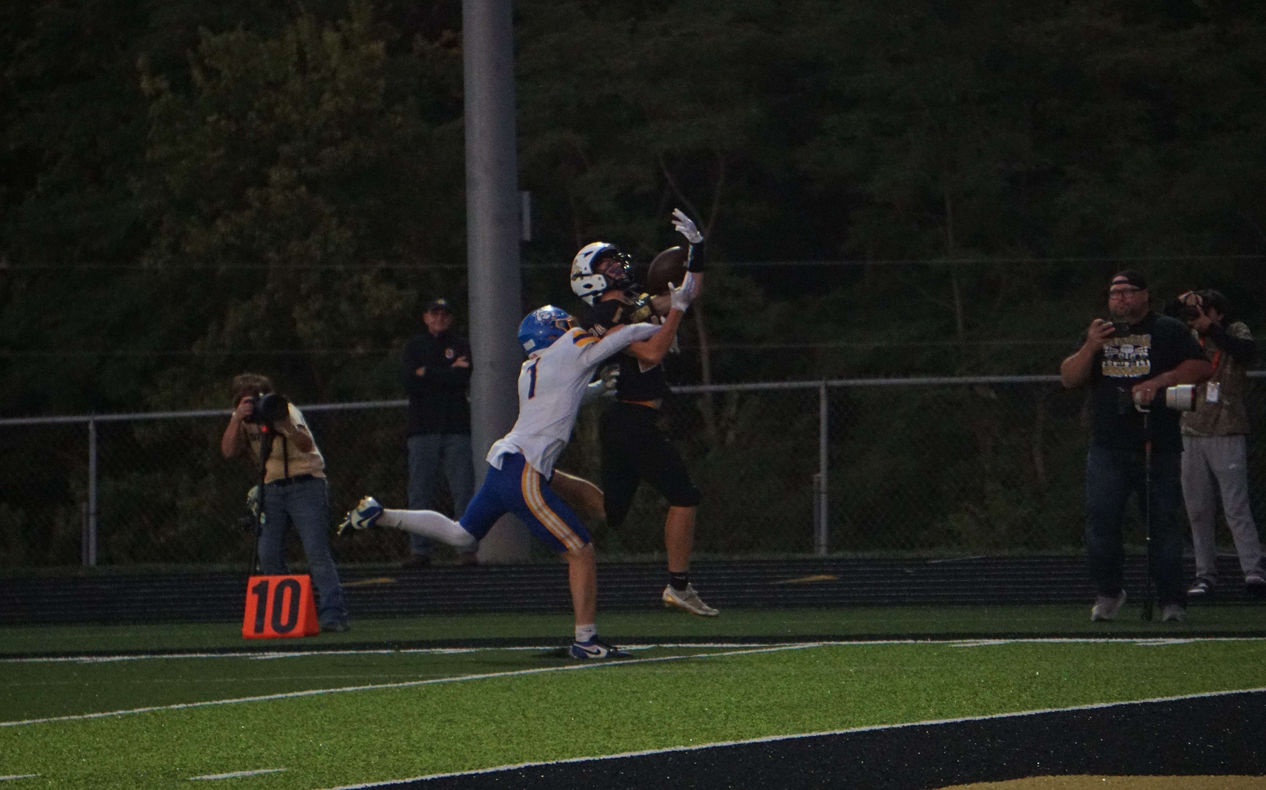 Luke Rogers (24) makes a contested catch against East Buchanan's Braxton Scott (1)/ Photo by Matt Pike