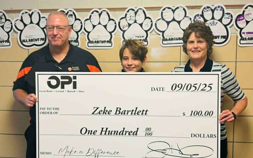 Park Elementary sixth-grade Zeke Bartlett is this year's first Make a Difference winner. Bartlett is surrounded by sixth-grade teacher Eric Dowson and Tina Koochel from OPI.