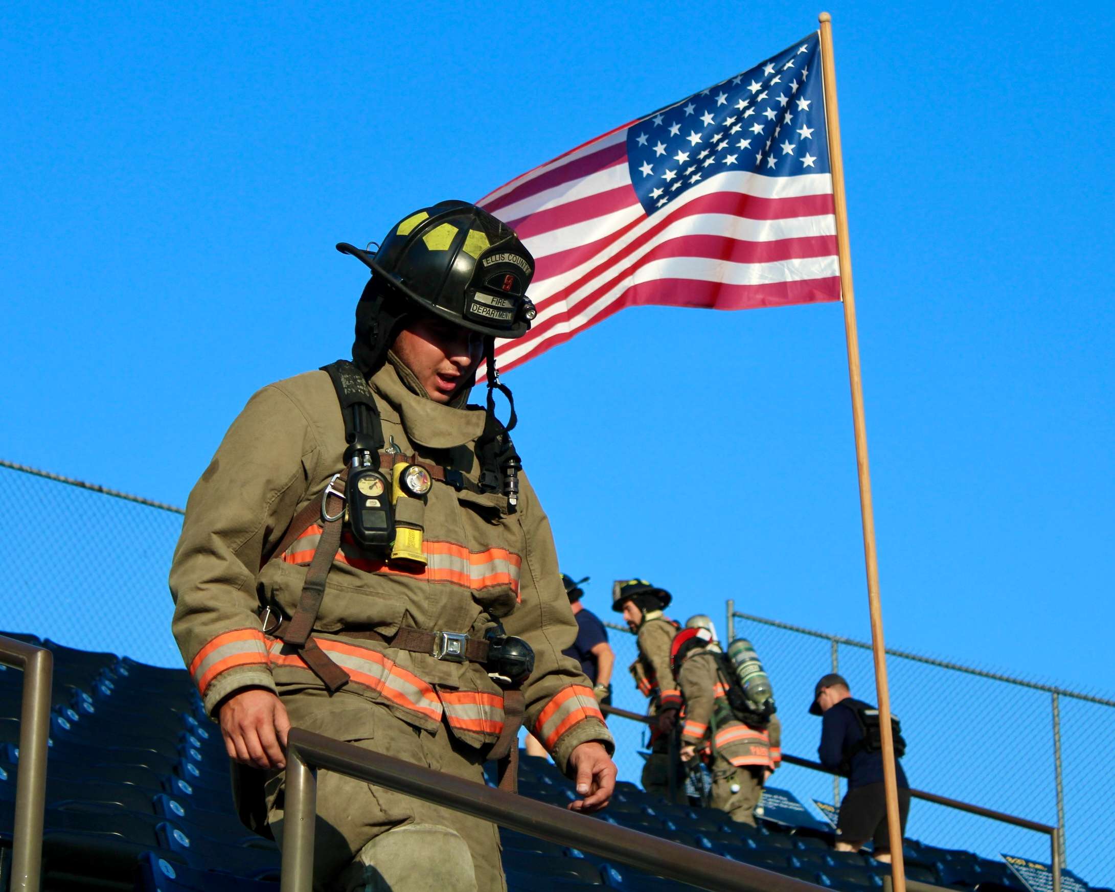 A firefighter climbing down the Lewis Field Stadium bleachers for the Fort Hays State University Memorial Stair Climb. Photo by Tony Guerrero/Hays Post