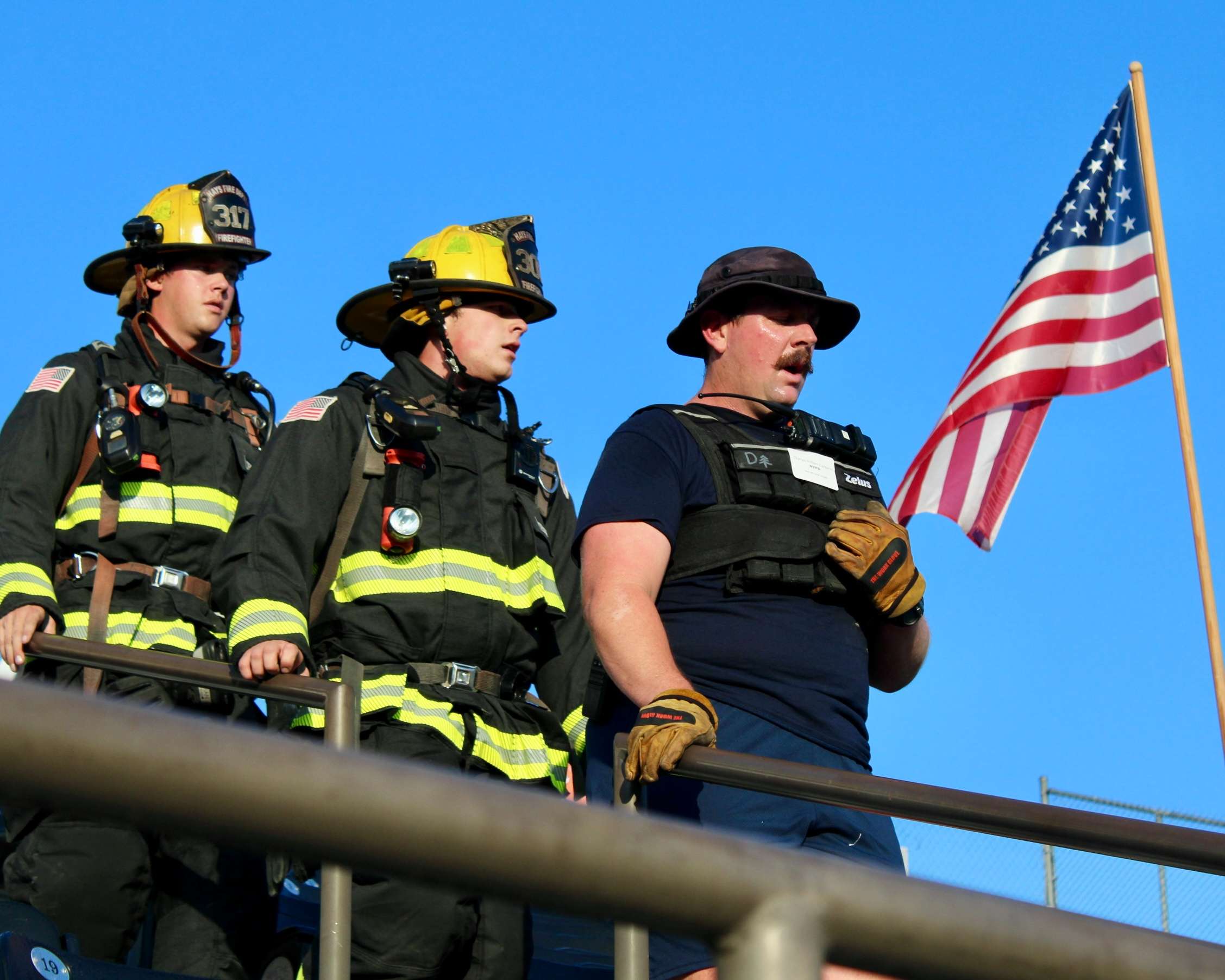 Firefighters climbing down the Lewis Field Stadium bleachers for the Fort Hays State University 9/11 Memorial Stair Climb. Photo by Tony Guerrero/Hays Post