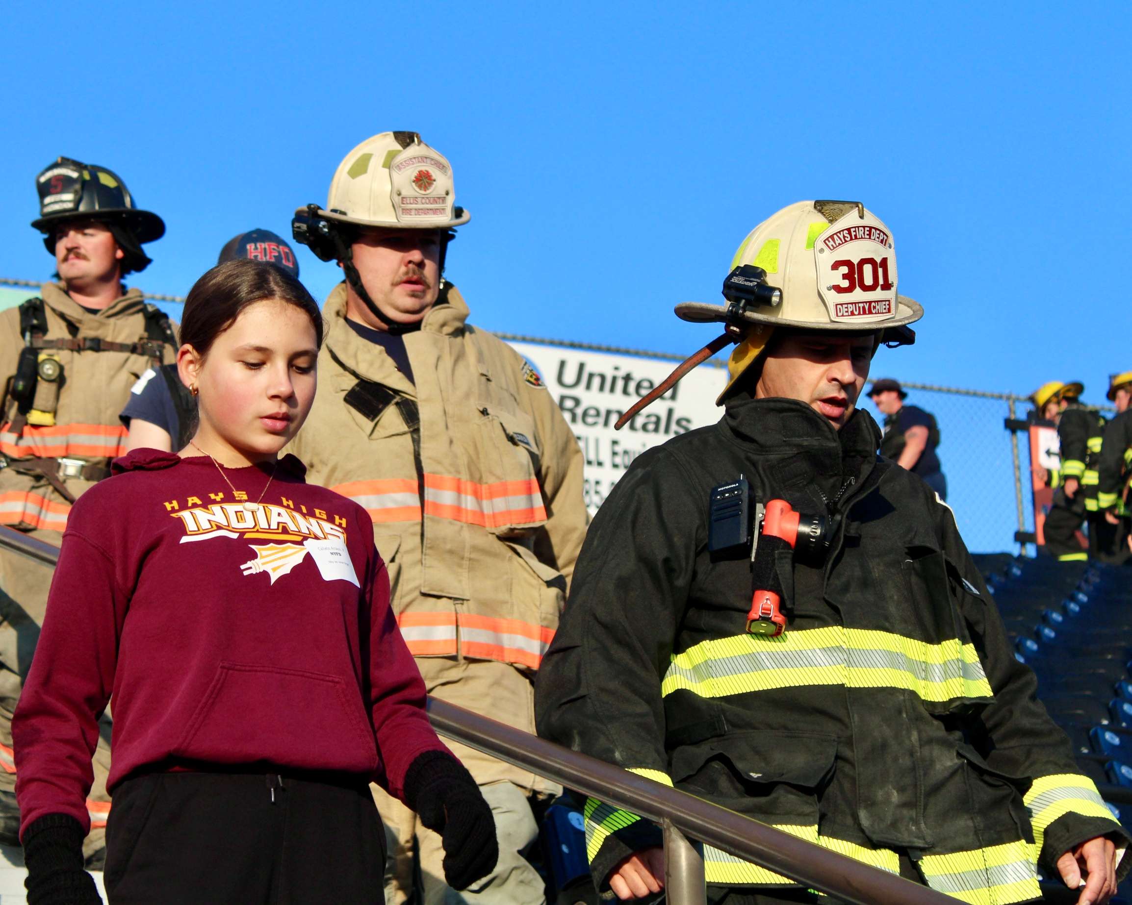 Firefighters and a participant climbing down the&nbsp;Lewis Field Stadium bleachers for the Fort Hays State University 9/11 Memorial Stair Climb. Photo by Tony Guerrero/Hays Post