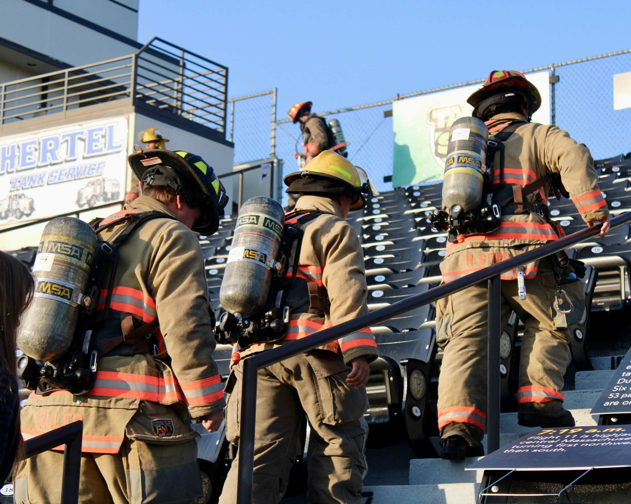Firefighters climbing up the Lewis Field Stadium bleachers for the Fort Hays State University 9/11 Memorial Stair Climb. Photo by Tony Guerrero/Hays Post&nbsp;