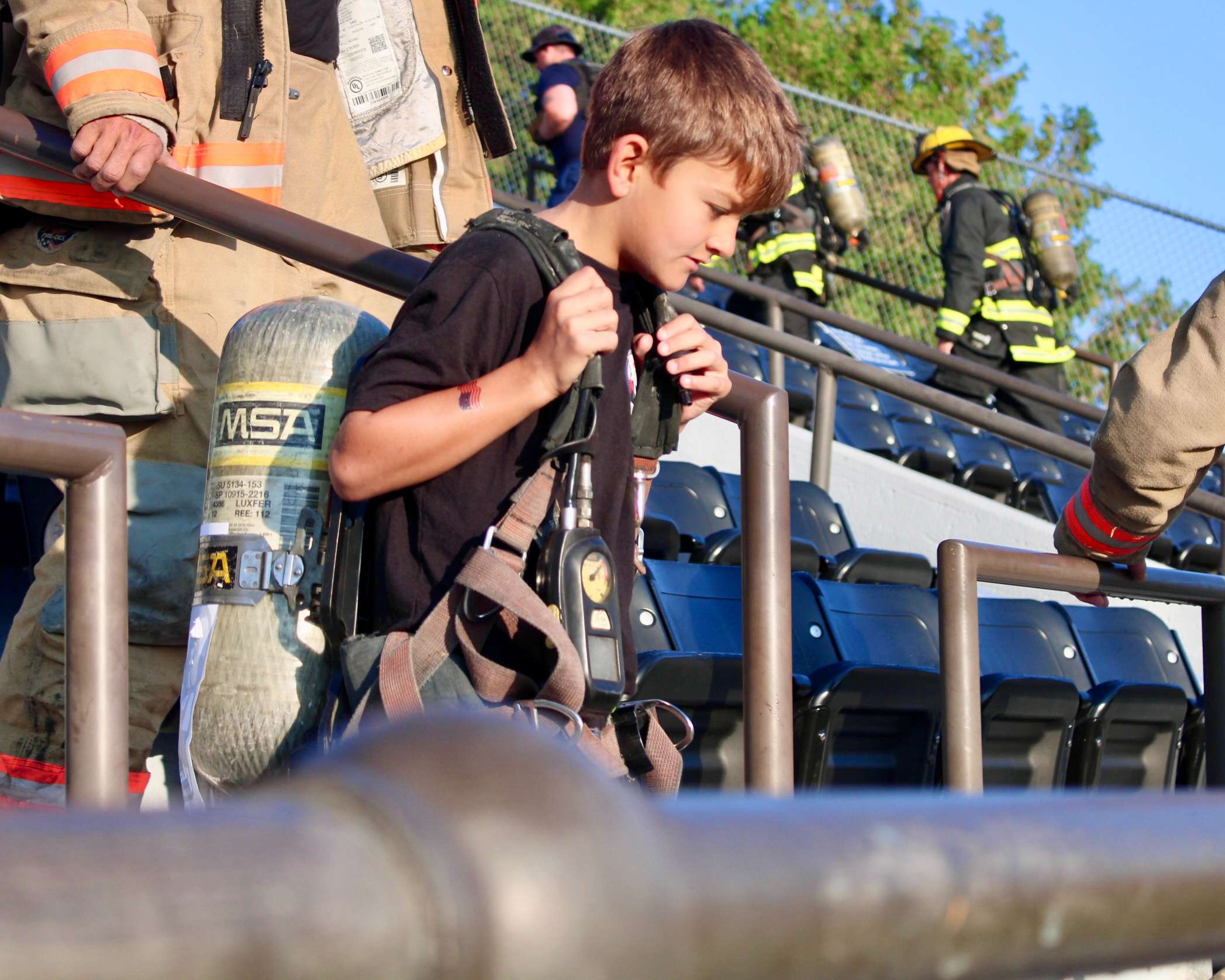 A young boy with firefighter gear&nbsp;at the 9/11 Memorial Stair Climb. Photo by Tony Guerrero/Hays Post