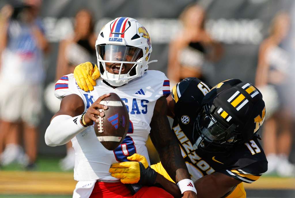 Kansas quarterback Jalon Daniels (6) is tackled by Missouri defensive end Darris Smith (19) after a five-yard gain during the second half of an NCAA college football game on Saturday, Sept. 6, 2025, in Columbia, Mo. (AP Photo/Colin E. Braley)