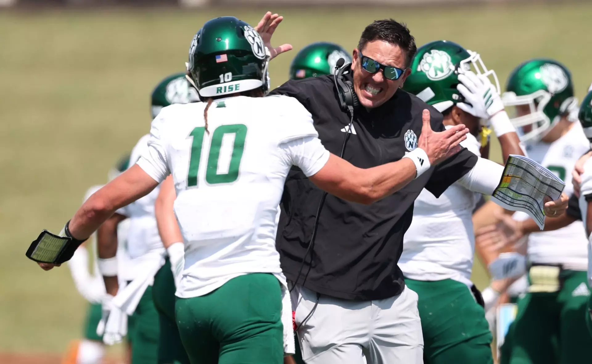 Northwest head coach John McMenamin celebrates with quarterback Zechariah Owens during Northwest's 34-7 win over Washburn/ Photo courtesy Aaron Hare of Northwest Athletics