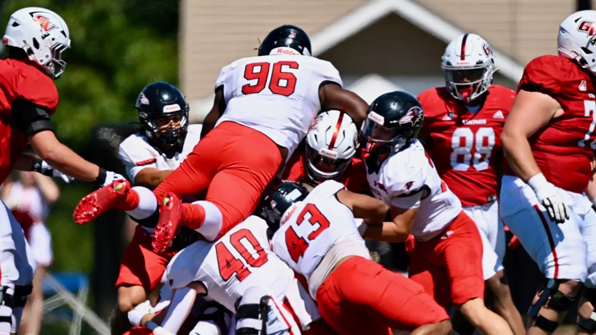 Benedictine's Kevin Harris (96) piles on to make a stop against Grandview during the Ravens 27-24 loss/ Photo courtesy of Raven Athletics