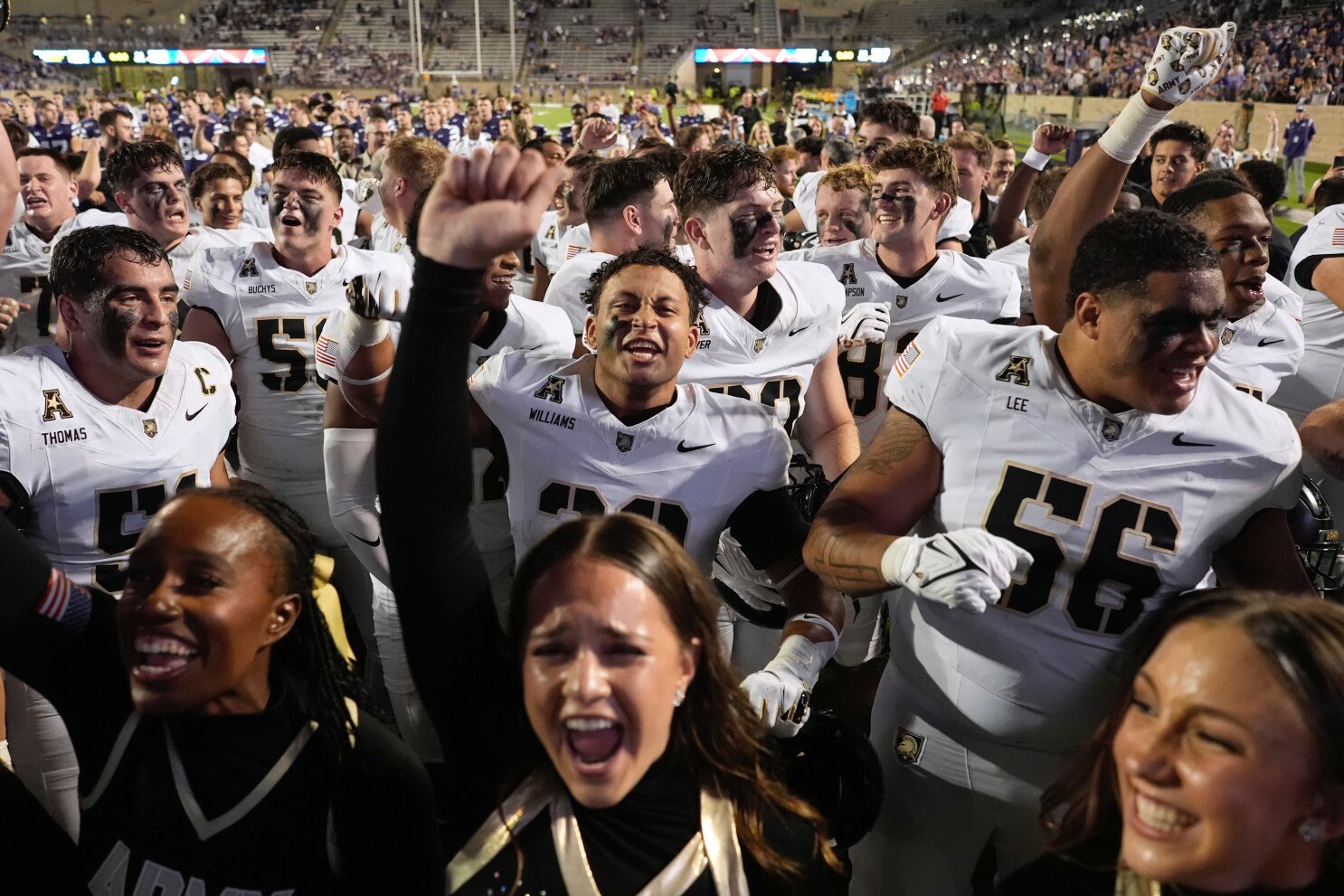 Army players and cheerleaders celebrate after beating Kansas State in an NCAA college football game Saturday, Sept. 6, 2025, in Manhattan, Kan. (AP Photo/Charlie Riedel)