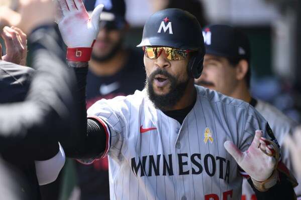 Minnesota Twins' Byron Buxton is congratulated after hitting a home run against the Kansas City Royals during the first inning of a baseball game in Kansas City, Mo., Sunday, Sept. 7, 2025. (AP Photo/Reed Hoffmann)