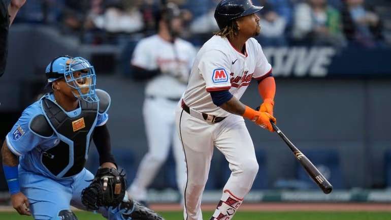 Cleveland Guardians' Jose Ramirez, right, and Kansas City Royals catcher Salvador Perez watch Ramirez's home run in the first inning of a baseball game in Cleveland, Tuesday, Sept. 9, 2025. (AP Photo/Sue Ogrocki)