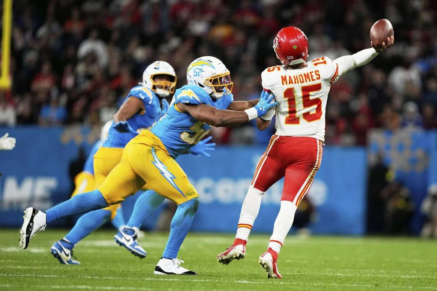 Kansas City Chiefs quarterback Patrick Mahomes passes under pressure from Los Angeles Chargers linebacker Khalil Mack during the second half of an NFL football game, Friday, Sept. 5, 2025, in Sao Paulo. (AP Photo/Doug Benc)