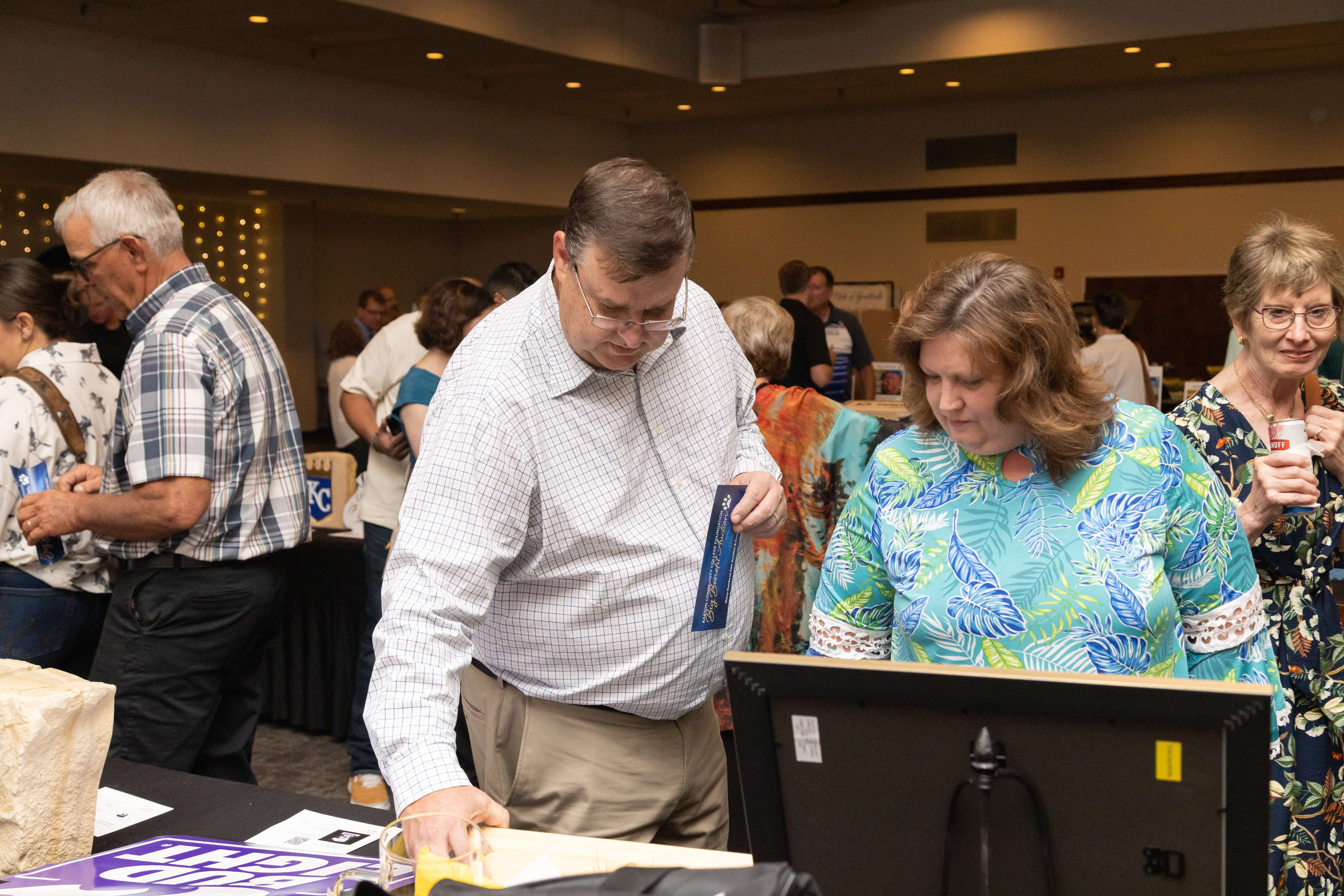 Attendees browse auction items during the Barton Foundation’s 46th Annual Big Benefit Auction, held Aug. 23 at the Great Bend Events Center. The event raised over $60,000 to support scholarships and program enhancements at Barton Community College.