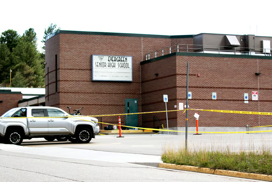 Police tape blocks the way to Evergreen High School after a shooting on Sept. 10, 2025. (Photo&nbsp;

Kevin J. Beaty/Denverite)