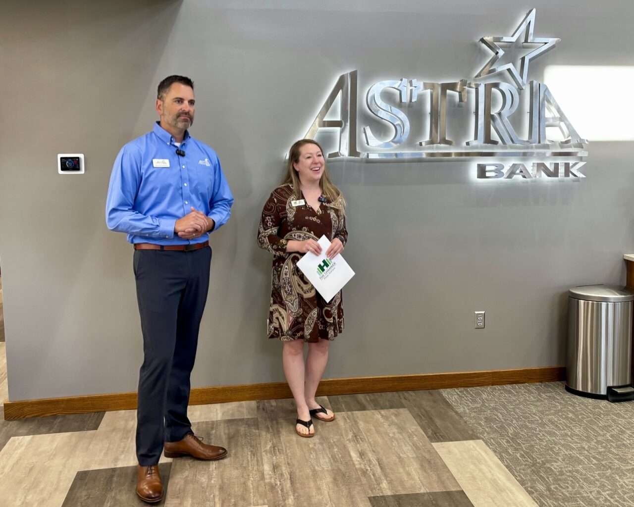 Jason Kennedy, Astra Bank market president, and Sarah Wasinger, president/CEO of The Chamber in Hays, speaking at the Astra Bank ribbon-cutting ceremony.<i> Photo by Tony Guerrero/Hays Post</i>