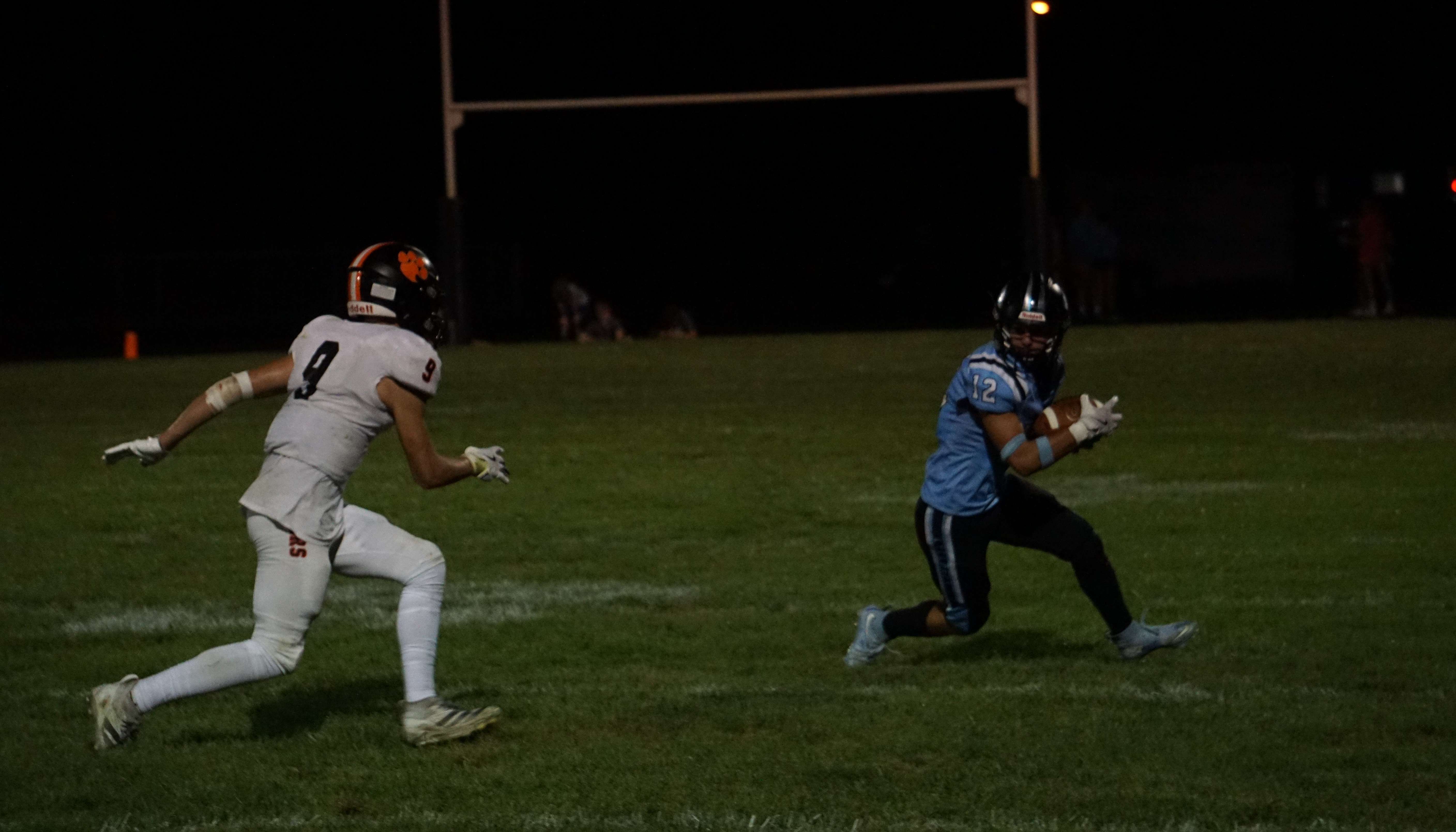 Riverside's Micah Robidou (12) looks to make a move against Atchison County's Rance Vessar (9)/ Photo by Matt Pike