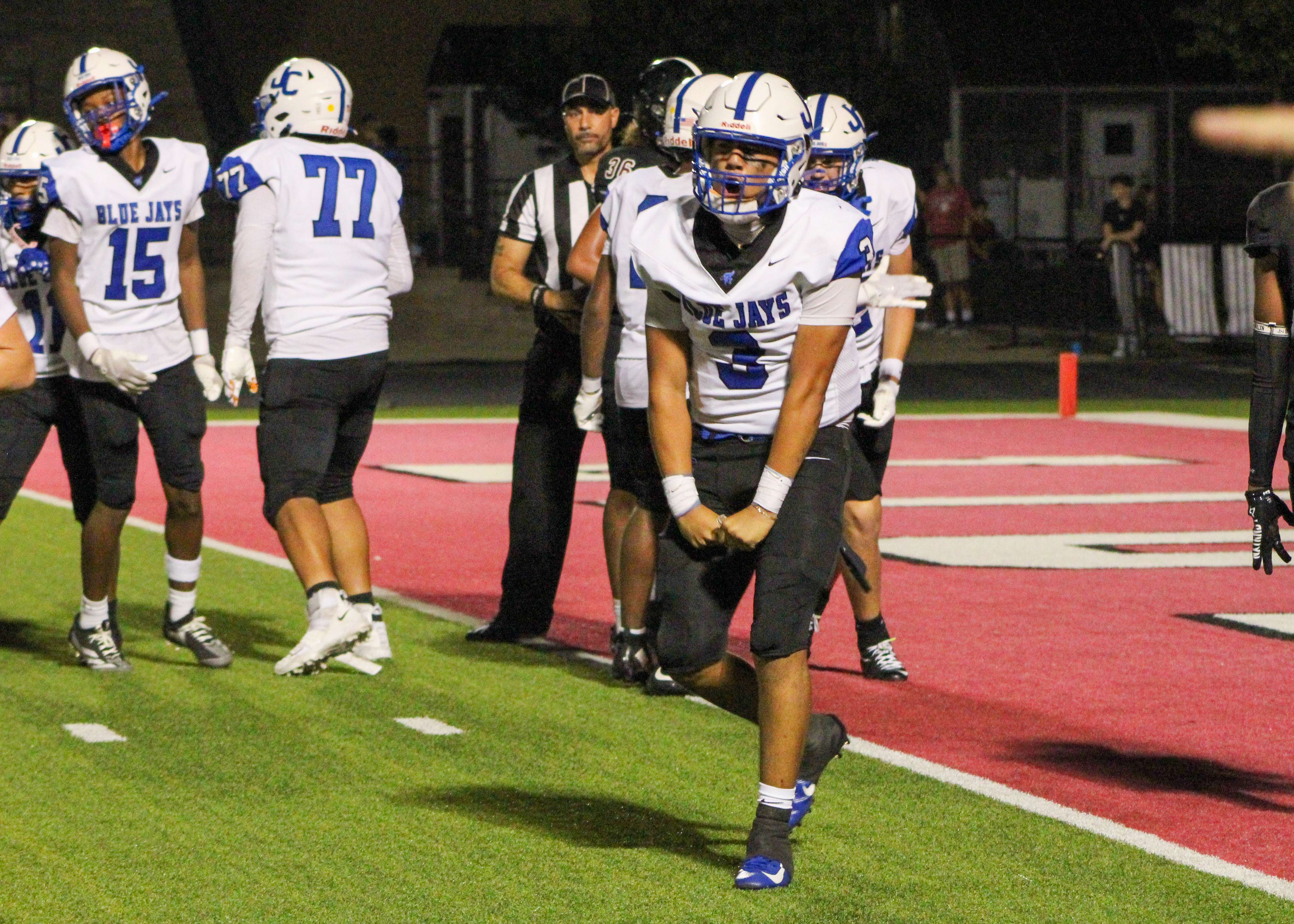 Senior quarterback Conrad Gomez celebrates a touchdown the Blue Jays scored on Friday night in Lawrence.