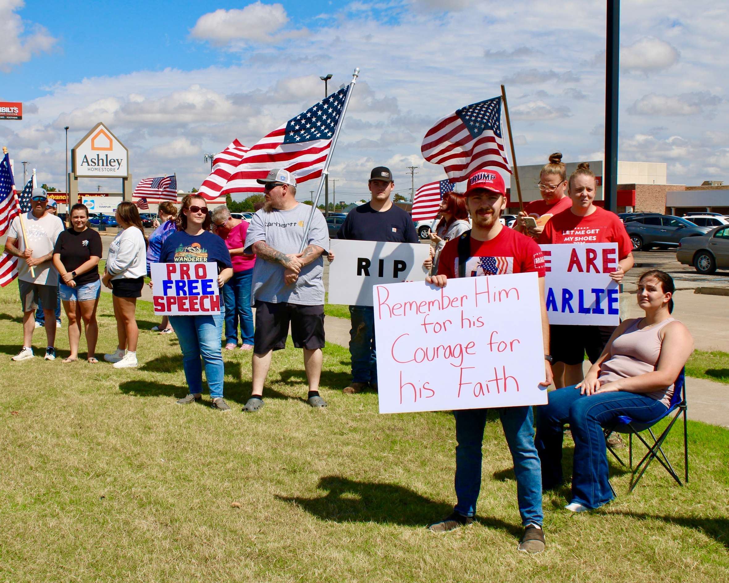 Kayson Unsworth with a sign (right) on the corner of 27th and Vine in Hays. Photo by Tony Guerrero/Hays Post