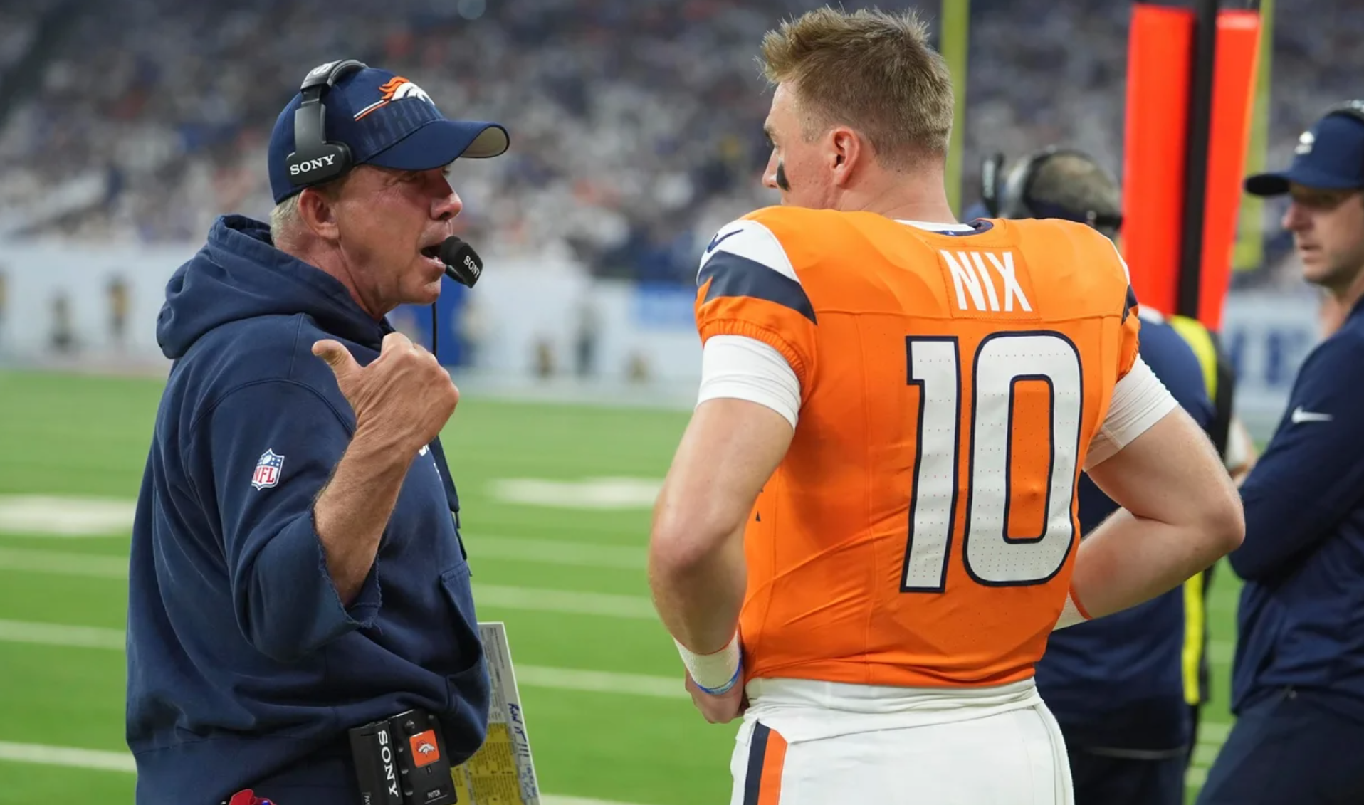 Denver Broncos head coach Sean Payton talks with quarterback Bo Nix during the first half an NFL football game against the Indianapolis Colts, Sunday, Sept. 14, 2025, in Indianapolis. (AP Photo/Michael Conroy)