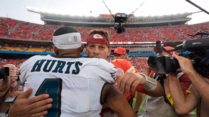 Kansas City Chiefs quarterback Patrick Mahomes and Philadelphia Eagles quarterback Jalen Hurts (1) hug following an NFL football game Sunday, Sept. 14, 2025, in Kansas City, Mo. (AP Photo/Charlie Riedel)