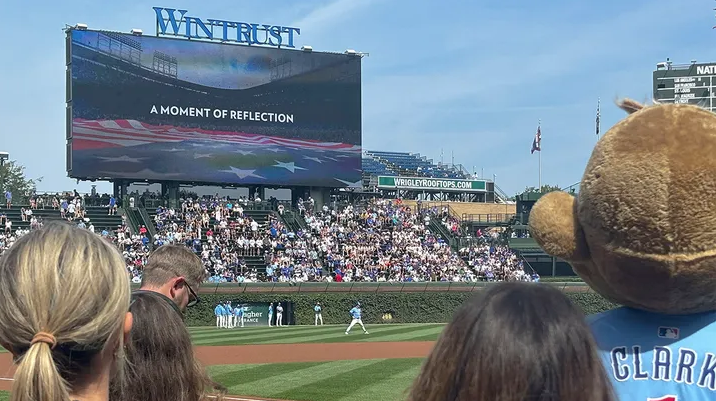 Fans look on during a moment of reflection following the death of Charlie Kirk before the game between the Chicago Cubs and the Tampa Bay Rays at Wrigley Field on Sept. 12, 2025. (Matt Marton/Imagn Images)